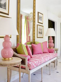 a living room filled with lots of pink furniture