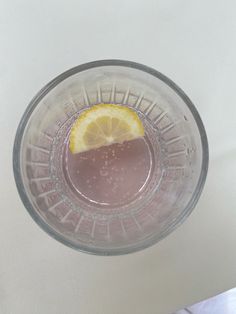 a glass with some liquid and a slice of lemon