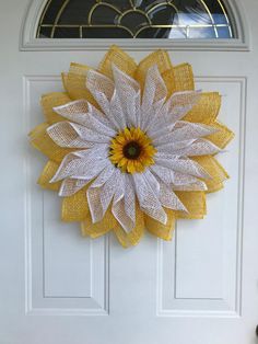 a yellow and white door with a sunflower on it