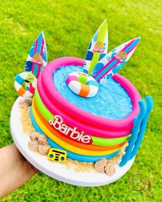 there is a birthday cake made to look like a beach floater on the grass