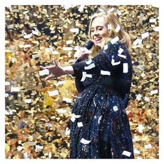 a woman standing in front of a bunch of confetti