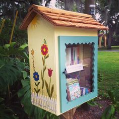 a painted mailbox in the middle of a garden