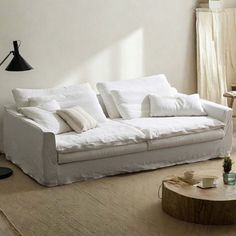 a living room with a white couch and coffee table