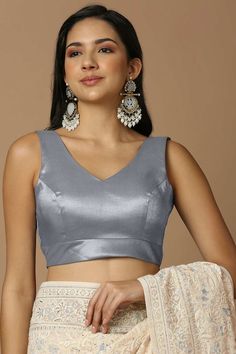 Product Features: Blouse Color: Grey Blouse Fabric: Silk Work: Solid Sleeve Length: Sleeveless In Closer: Back Open Padded / Non Padded : Padded Wash Care : Dry Clean Occasion : Festivewear, Partywear, Wedding Guest Product Type : Blouse Disclaimer: There will be slight difference in digital to actual image Elegant Sleeveless Crop Top, Sleeveless Crop Top For Party, Fitted V-neck Tank Top For Wedding, Party Vest Blouse, Padded V-neck Tank Top, Sleeveless Blouse Crop Top For Party, Elegant Party Blouse With Vest Detail, Elegant Tank Blouse For Party, Elegant Party Blouse Vest