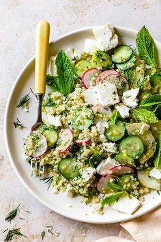 a white plate topped with cucumbers, radishes and feta cheese