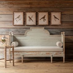 a white couch sitting next to a wooden wall