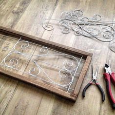 scissors and wire are laying on the floor next to an old window frame that has been cut into smaller pieces