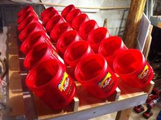 red plastic cups are lined up on a shelf