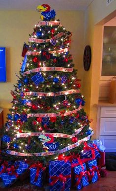 a christmas tree decorated with red, white and blue ribbons