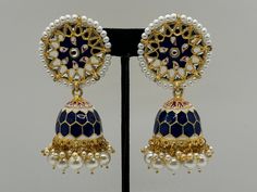 Experience the epitome of elegance with these Royal Blue and Gold Jhumka Earrings, beautifully handcrafted to celebrate Indian heritage. These exquisite earrings feature an intricate floral design adorned with pearls, leading to a dome-shaped jhumka with a stunning blue enamel lattice pattern. The combination of gold detailing and delicate pearls adds a touch of sophistication and regality, making these earrings perfect for special occasions and festive events. Blue Temple Jewelry Jhumkas For Celebration, Traditional Blue Earrings With Intricate Design, Temple Style Blue Jhumkas For Celebration, Blue Festive Jhumkas Drop Earrings, Blue Jhumkas Drop Earrings For Festive Occasions, Blue Jhumkas With Latkans Drop Earrings, Blue Temple Jewelry Earrings With Latkans, Blue Temple Jewelry Jhumkas Gift, Blue Cutdana Earrings For Wedding