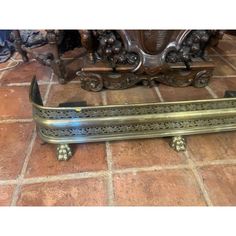 an ornately designed bench sits on a tile floor