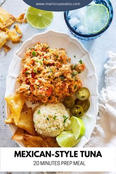 mexican - style tuna with rice and olives on a white plate next to chips