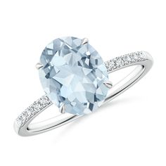 an oval blue topaz ring with diamonds on the band and side stones in white gold