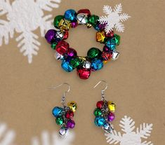 a pair of christmas bells are hanging from earrings