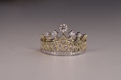 a gold and diamond tiara is shown on a white surface with the crown in view