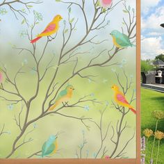 there are many birds perched on the branches of trees and flowers in front of a building