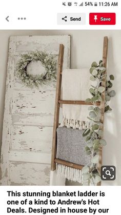 an old ladder is used as a towel rack for towels and wreaths on the wall