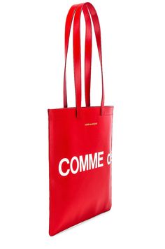 Find COMME DES GARÇONS Logo Tote Bag on Editorialist. This tote bag from COMME des GARCONS is crafted from smooth cow leather. It features a twill lining, double shoulder straps that measure approximately 25 inches in length with a 10 inch drop, and an interior zip pocket. The bag measures approximately 14 inches wide by 13 inches high by 0.25 inches deep. It features a printed logo detail and a gold foil logo detail. Red Calf Leather Bag With Soft Texture, Red Calf Leather Bag With Soft Finish, Soft Calf Leather Red Bag, Red Business Bag With Smooth Grain, Designer Red Calf Leather Bag, Red Calf Leather Shopping Bag, Red Calf Leather Bag For Shopping, Red Calf Leather Bag For Business, Red Calf Leather Travel Bags