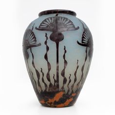 an artistic vase with seaweed and corals painted on the outside, against a white background