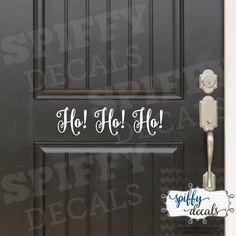 happy holidays door hanger on black front door with white lettering that reads,'happy holidays '