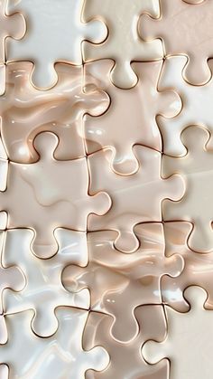 a large piece of white jigsaw puzzle sitting on top of a table next to a wall