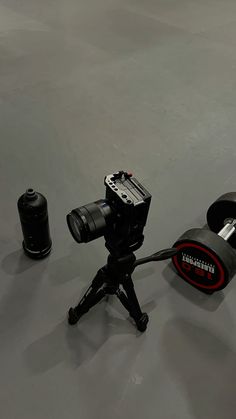 a camera sitting on top of a tripod next to other items in a room