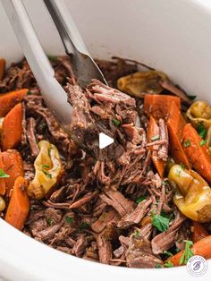 a white bowl filled with beef and carrots next to a fork in the bowl