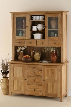 a wooden china cabinet with glass doors and drawers