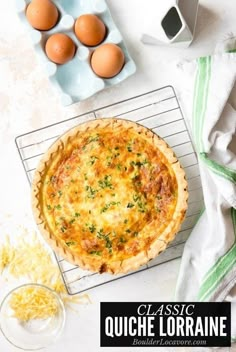 a quiche sitting on top of a cooling rack next to an egg and cheese dish