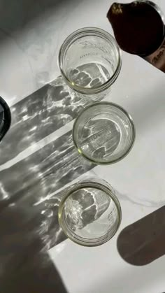 three empty glass cups sitting on top of a counter