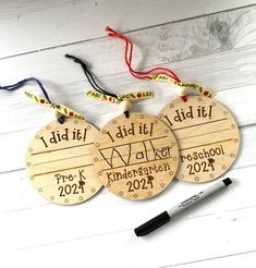 three wooden ornaments with writing on them