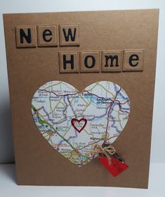 a new home card with a map heart and tag attached to the front of it