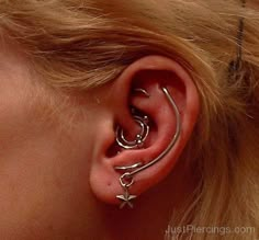 a close up of a person with ear piercings