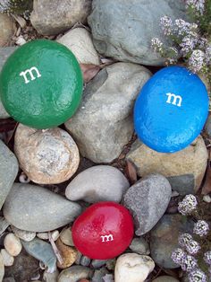 three rocks with the letters m and m painted on them