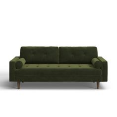 a green couch sitting on top of a white floor