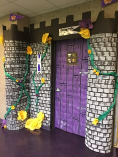 two purple doors with yellow flowers on them in front of a brick wall and door