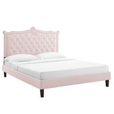 a pink bed with gold legs and headboard