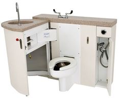 a white toilet sitting next to a sink in a bathroom under a faucet