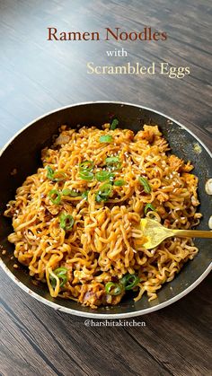 ramen noodles with scrambled eggs in a frying pan on a wooden countertop