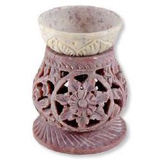 a ceramic vase with an intricate design on the top and bottom, sitting in front of a white background