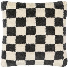 a black and white checkered pillow on a white background