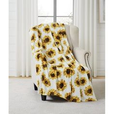 a sunflower blanket sitting on top of a chair