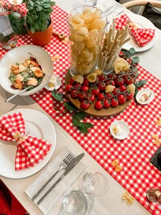 the table is set with plates, silverware and utensils for desserts