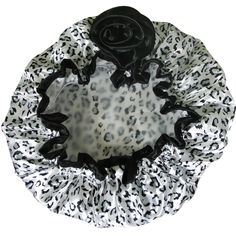 a black rose on top of a white and black leopard print ruffled hair scrunffle