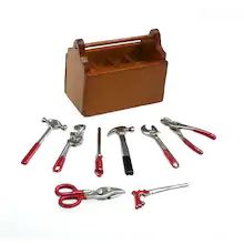 a wooden tool box filled with tools on top of a white table next to scissors and pliers