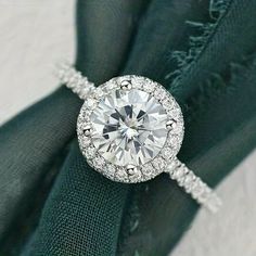 a diamond ring on top of a green napkin