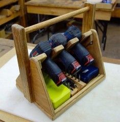 a group of drillers sitting inside of a wooden holder on top of a table