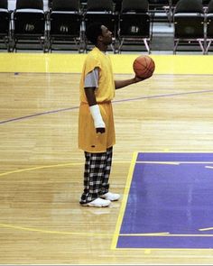 a man in an orange shirt holding a basketball