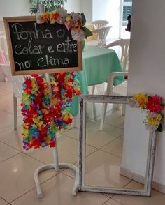 a sign that is on the side of a chair in front of a table with flowers