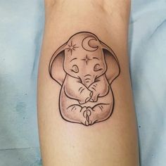 an elephant with a crescent moon tattoo on it's leg